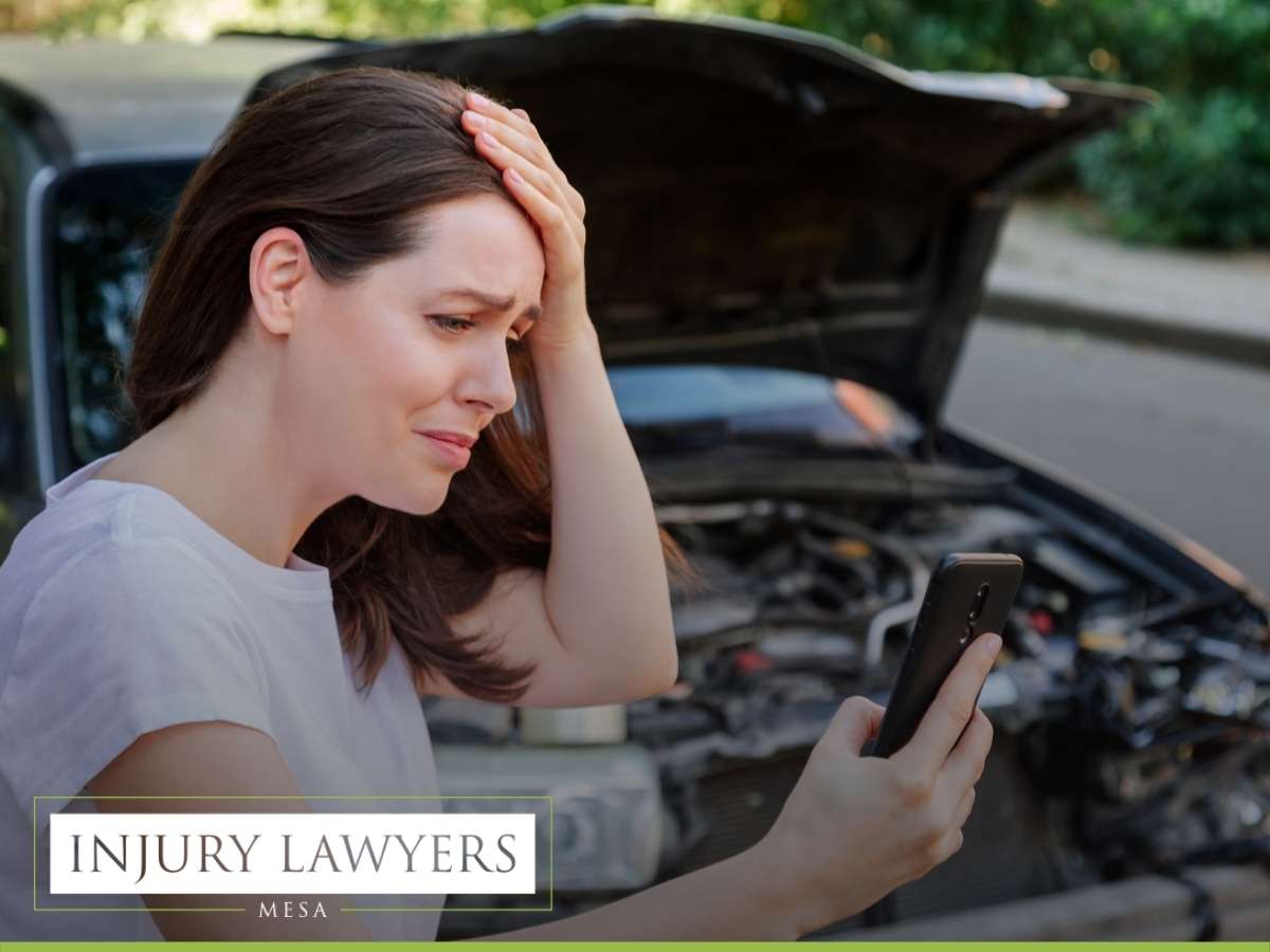 woman in stress holding her head after auto crash in Arizona
